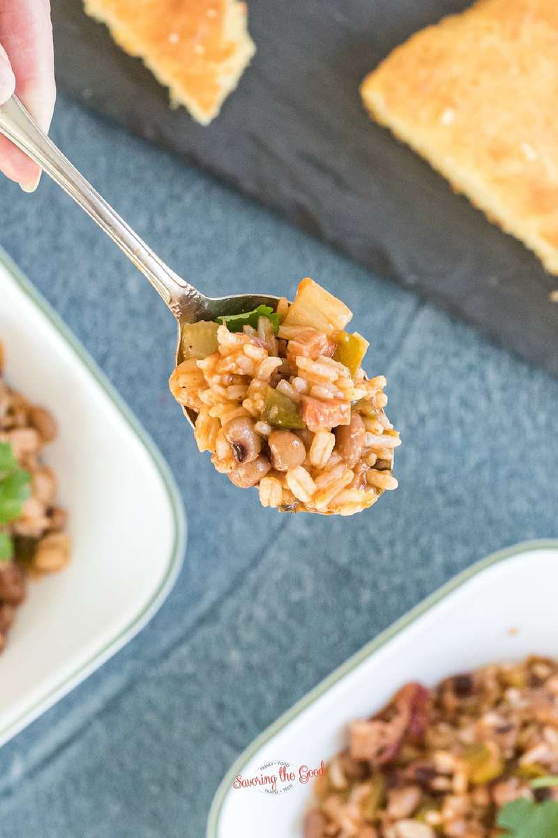 spoonful of carolina beans and rice over a blue surface