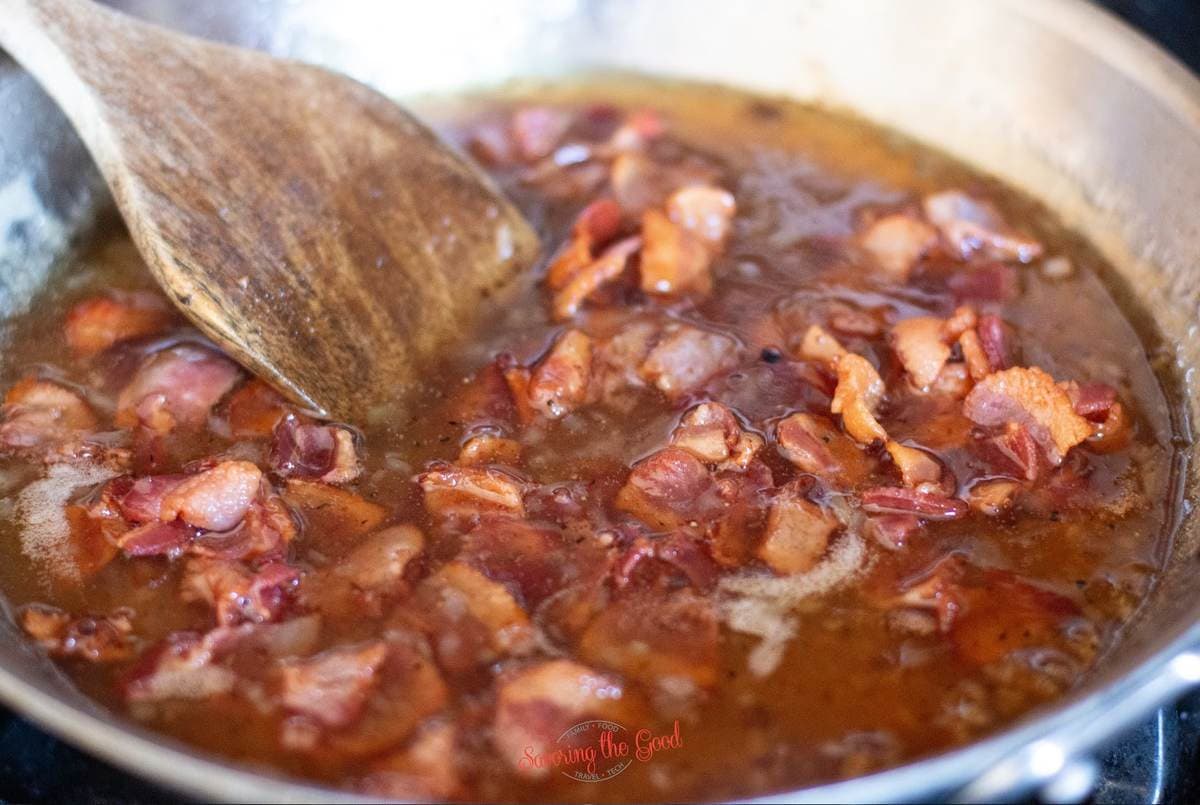 Hot Bacon Dressing in a pan simmering horizontal image