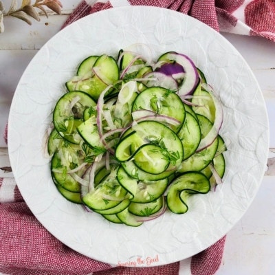 cucumber onion salad recipe on a white plate square image