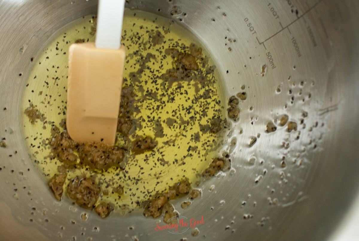 oil and garlic being mixed together in a bowl