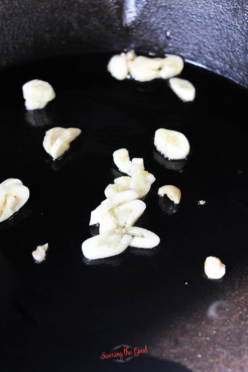 sautee garlic in a black pan