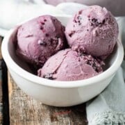 black raspberry ice cream, 3 scoops in a white bowl square image