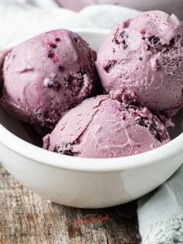 black raspberry ice cream, 3 scoops in a white bowl square image