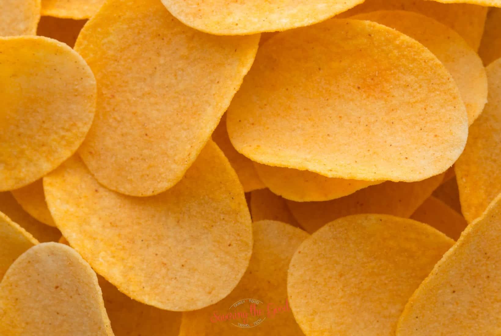 A pile of potato chips on a white background.