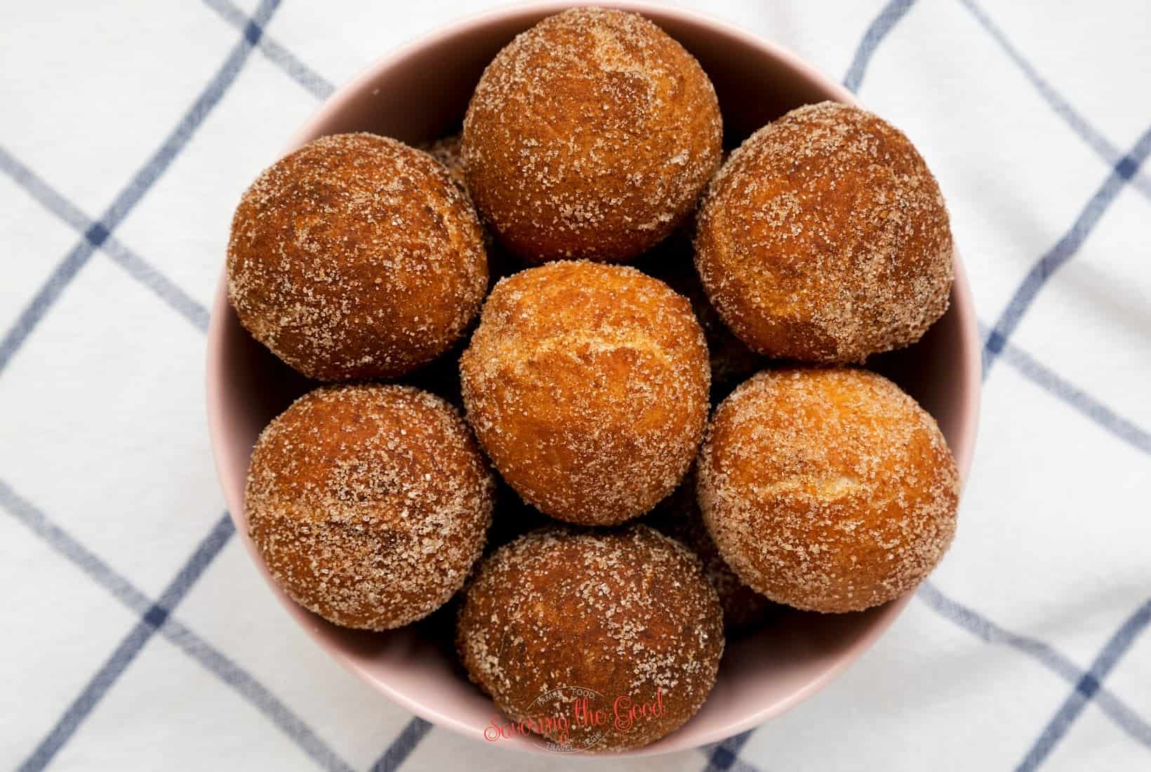 Cinnamon sugar chapssal donuts in a pink bowl.