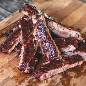 Bbq ribs on a wooden cutting board. as featured image for what to serve with bbq ribs.