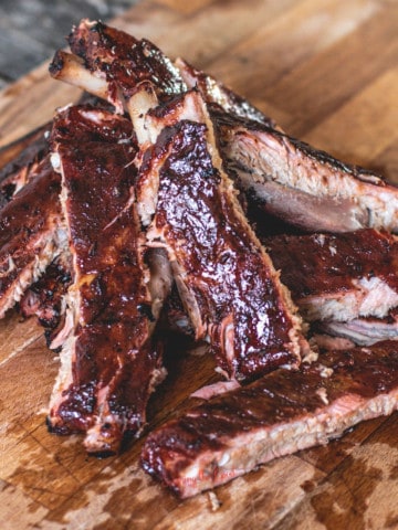 Bbq ribs on a wooden cutting board. as featured image for what to serve with bbq ribs.