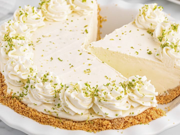 A no bake key lime pie with a slice taken out of it.