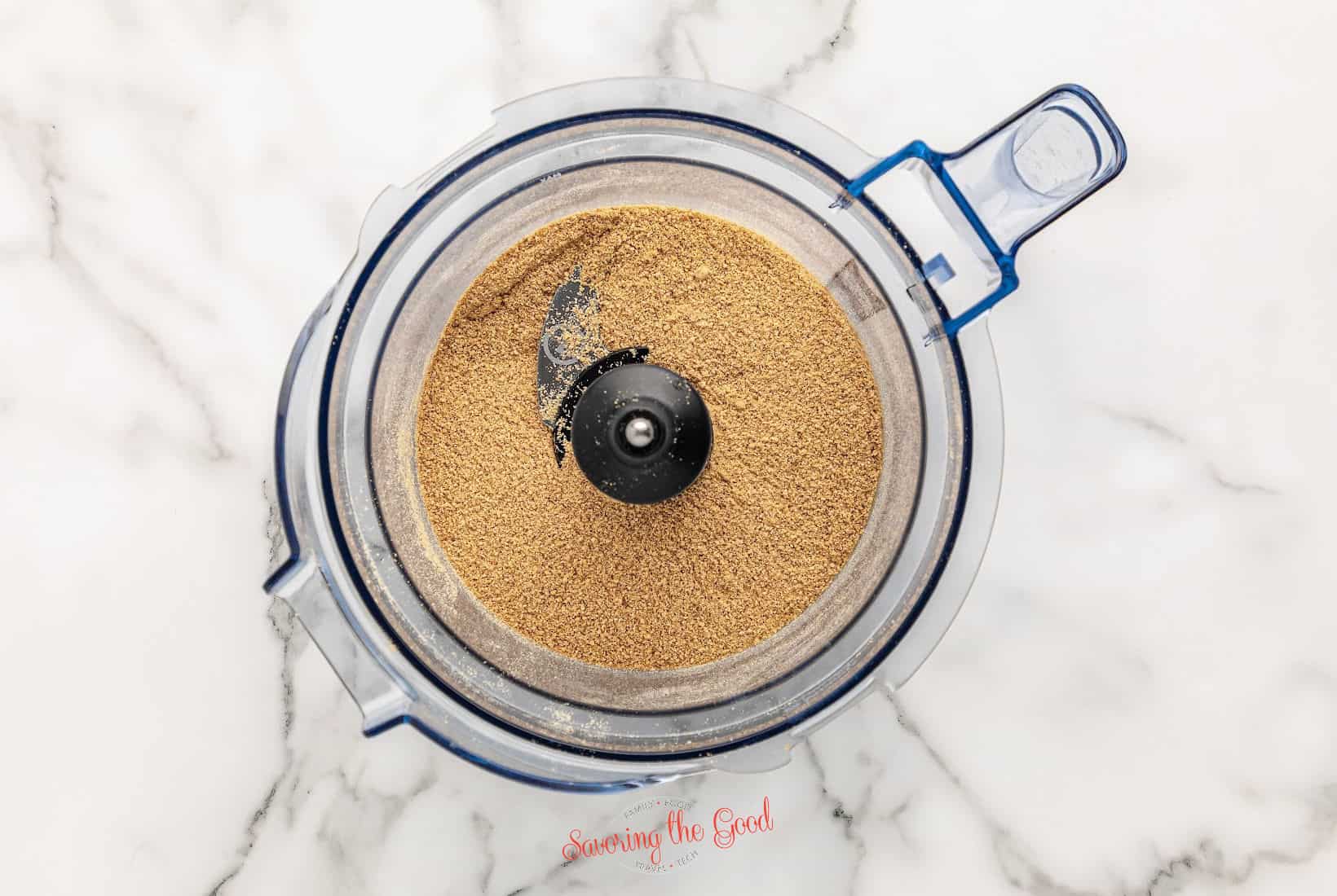 A food processor filled with graham cracker crumbs