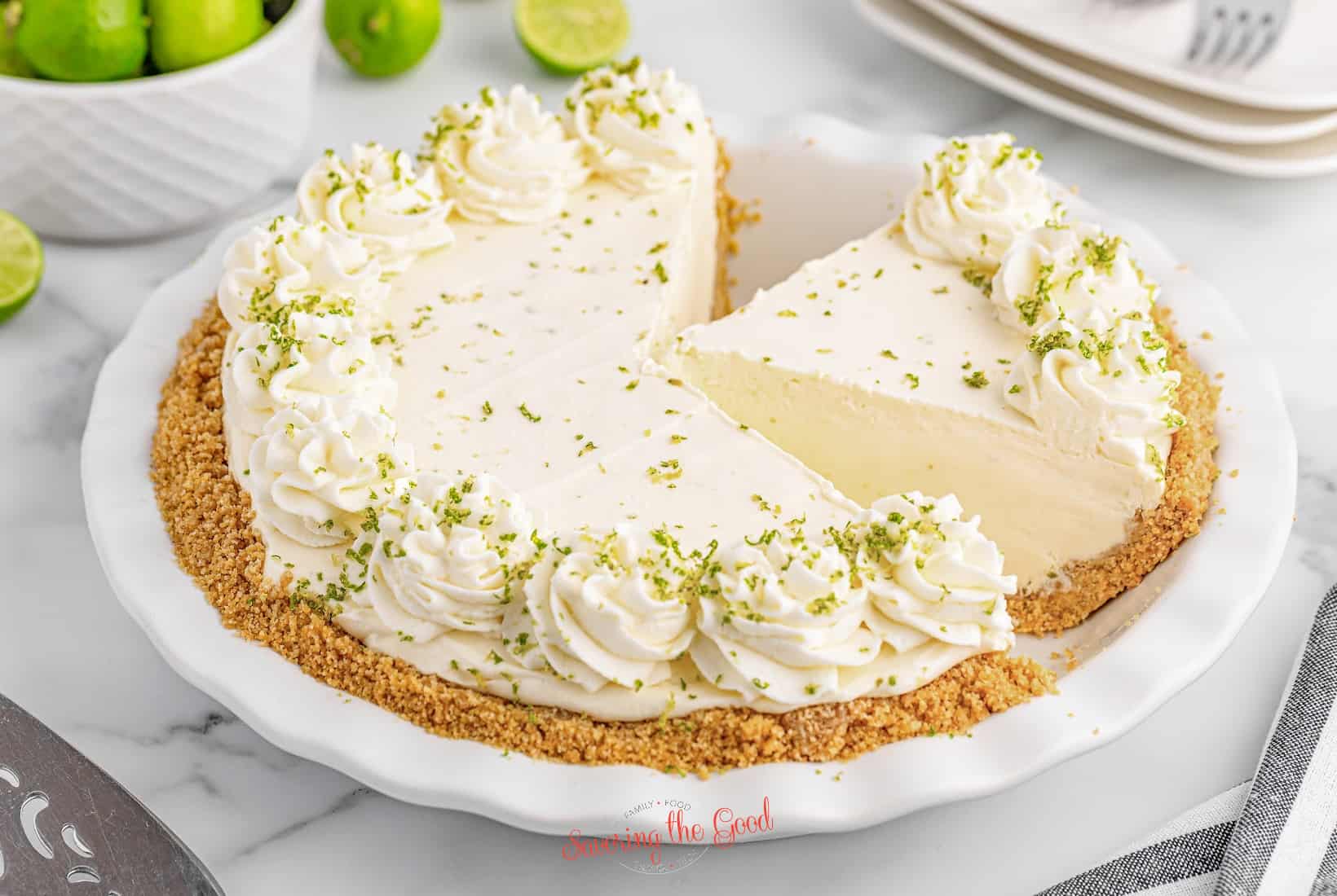 A lime pie with a slice taken out.