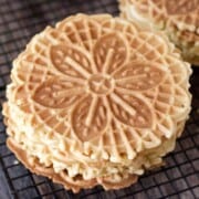 stack of 5 lemon pizzelle cookies on a cooling rack