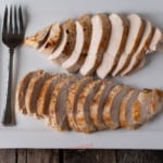 sous vide chicken breasts sliced and fanned out on a white platter