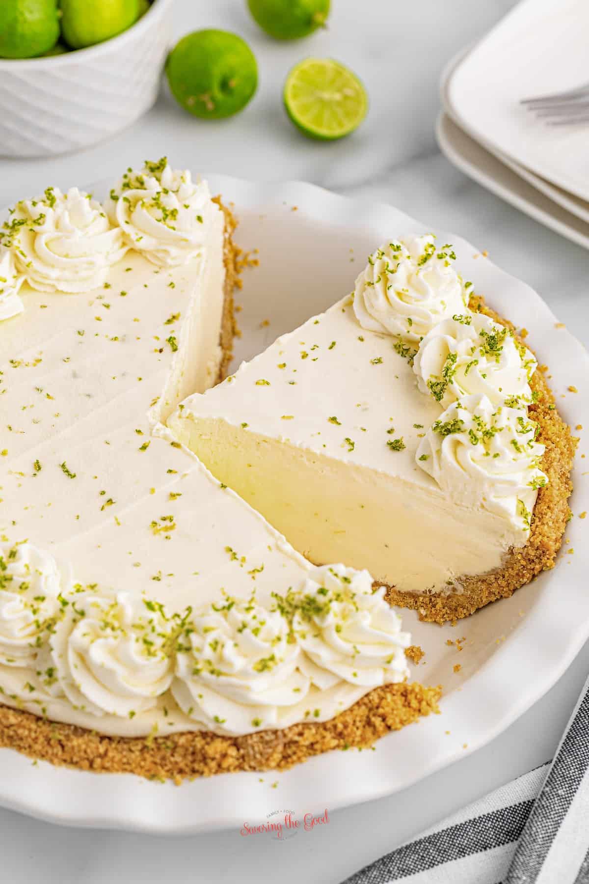 A no bake key lime pie with a slice taken out.