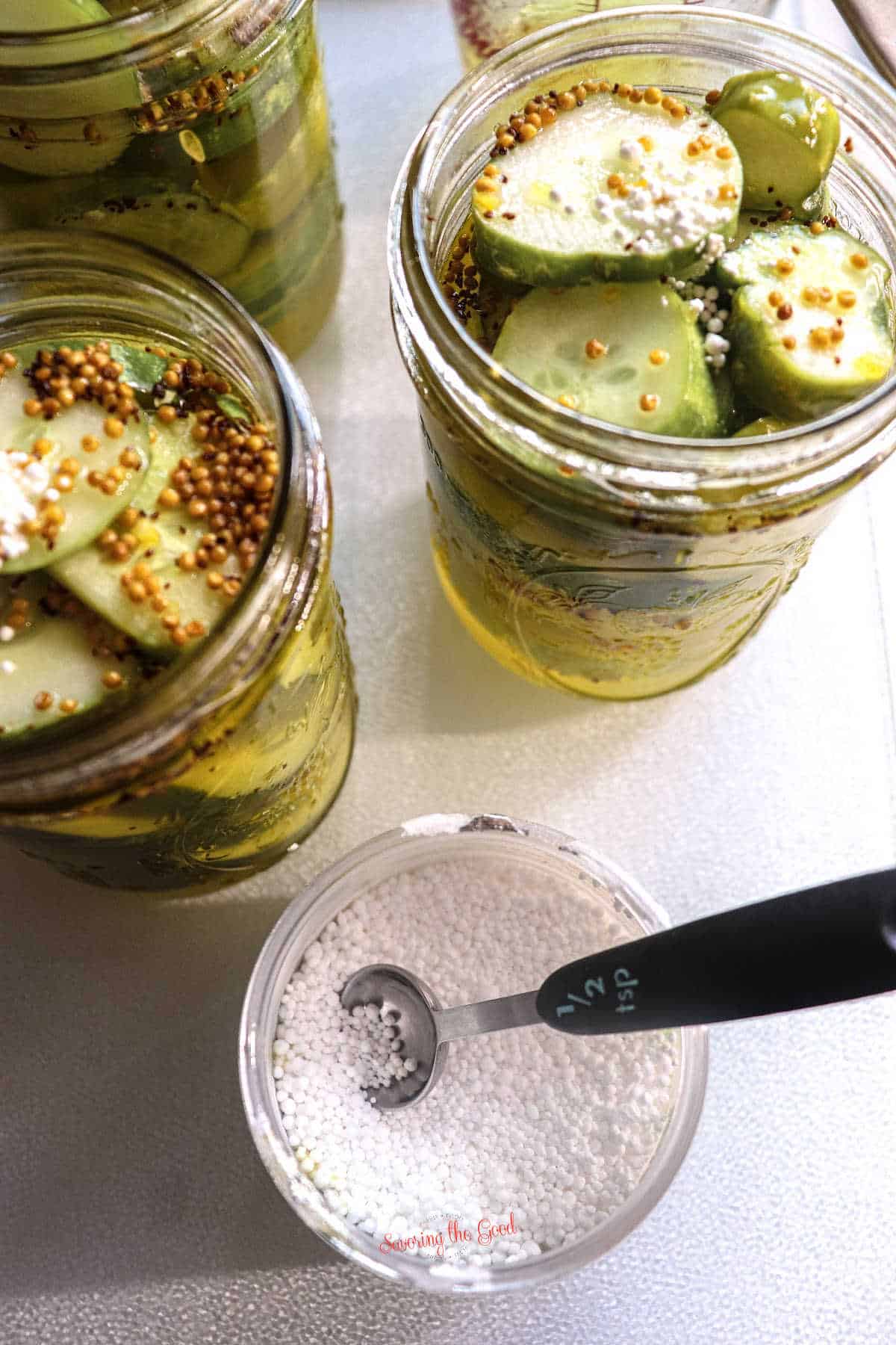jar of extra crisp granuals with a 1:2 teaspoon in it, jars of pickles and spices