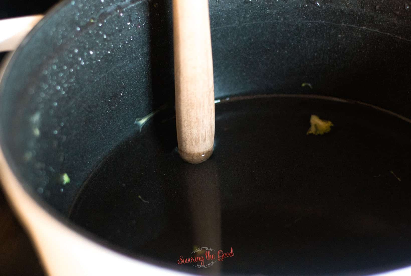 wooden spoon handle showing how deep to make the water for steaming