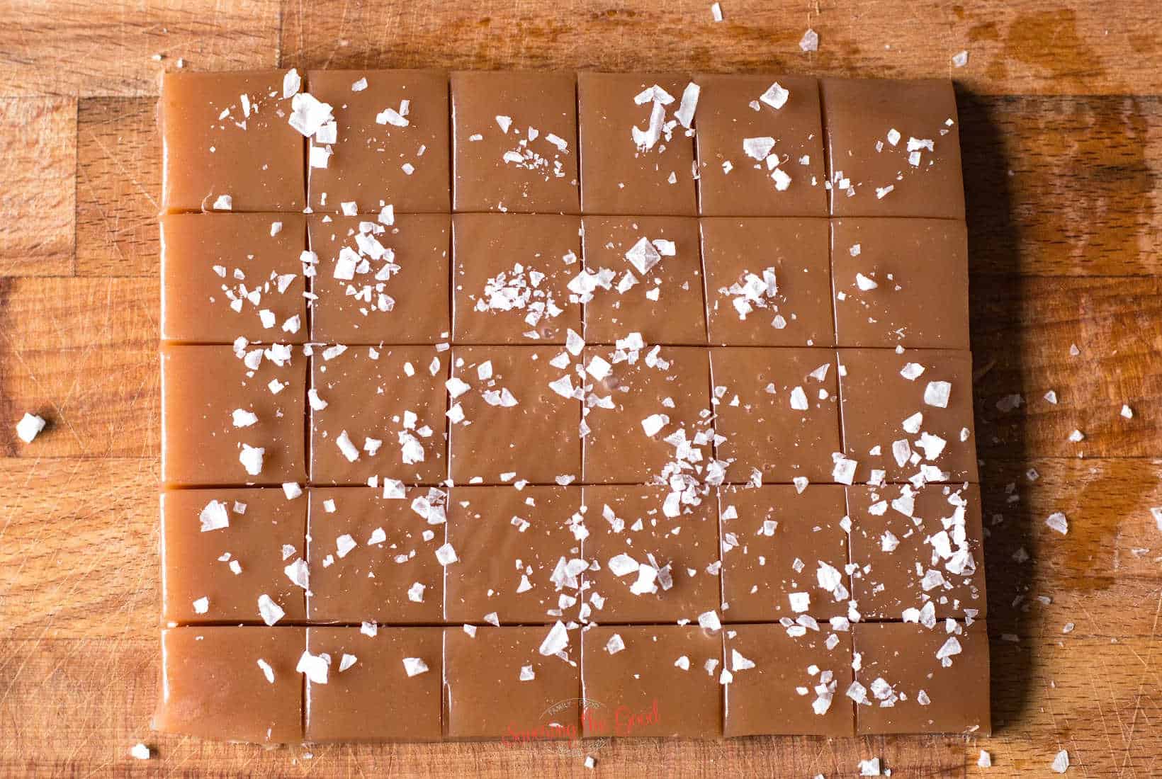 slab of soft caramels cut into squares with sea salt flakes