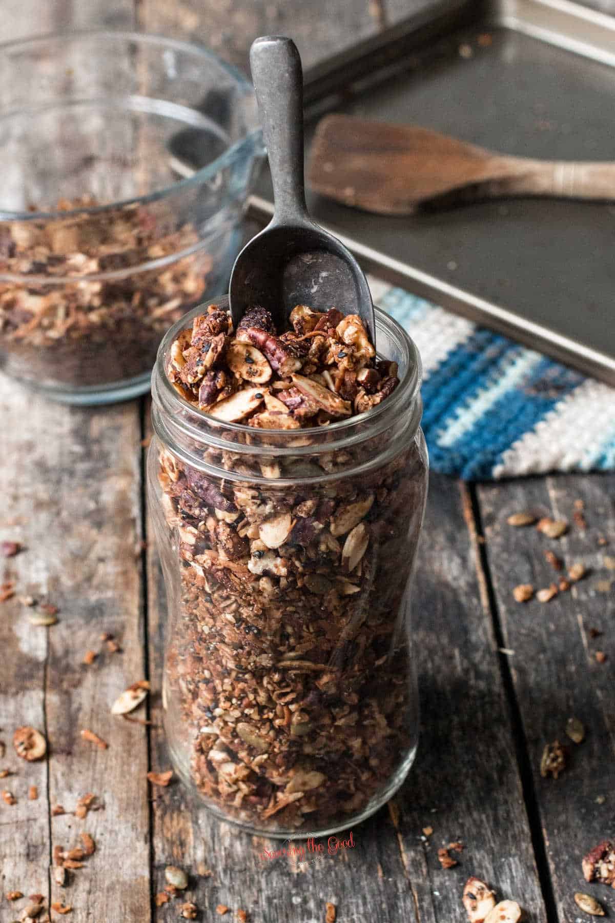 keto granola in a mason jar with baking sheet in the background
