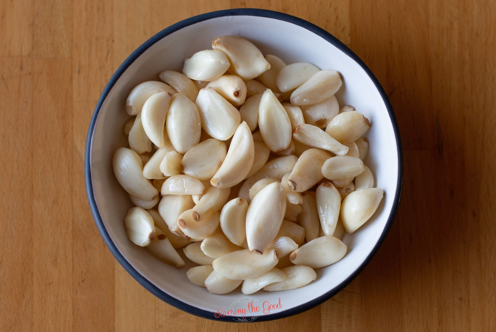 raw garlic cloves in a bowl