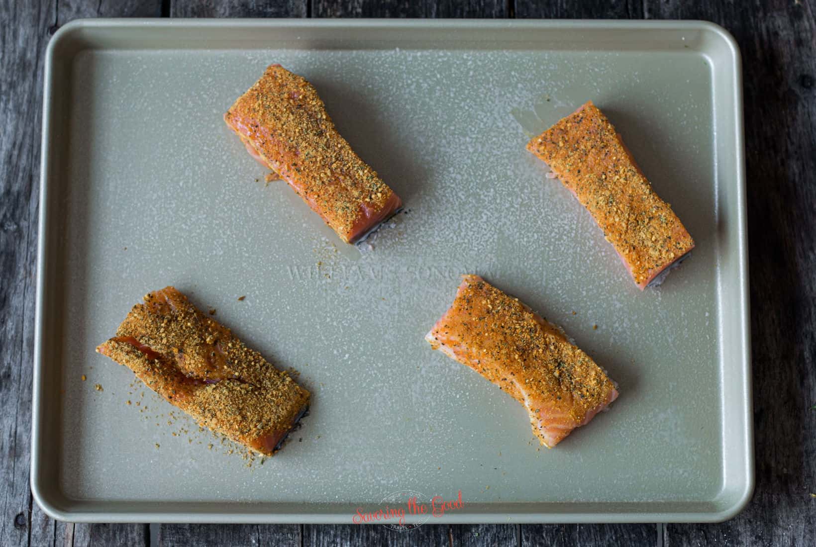seasoned salmon pieces on a sheet pan.