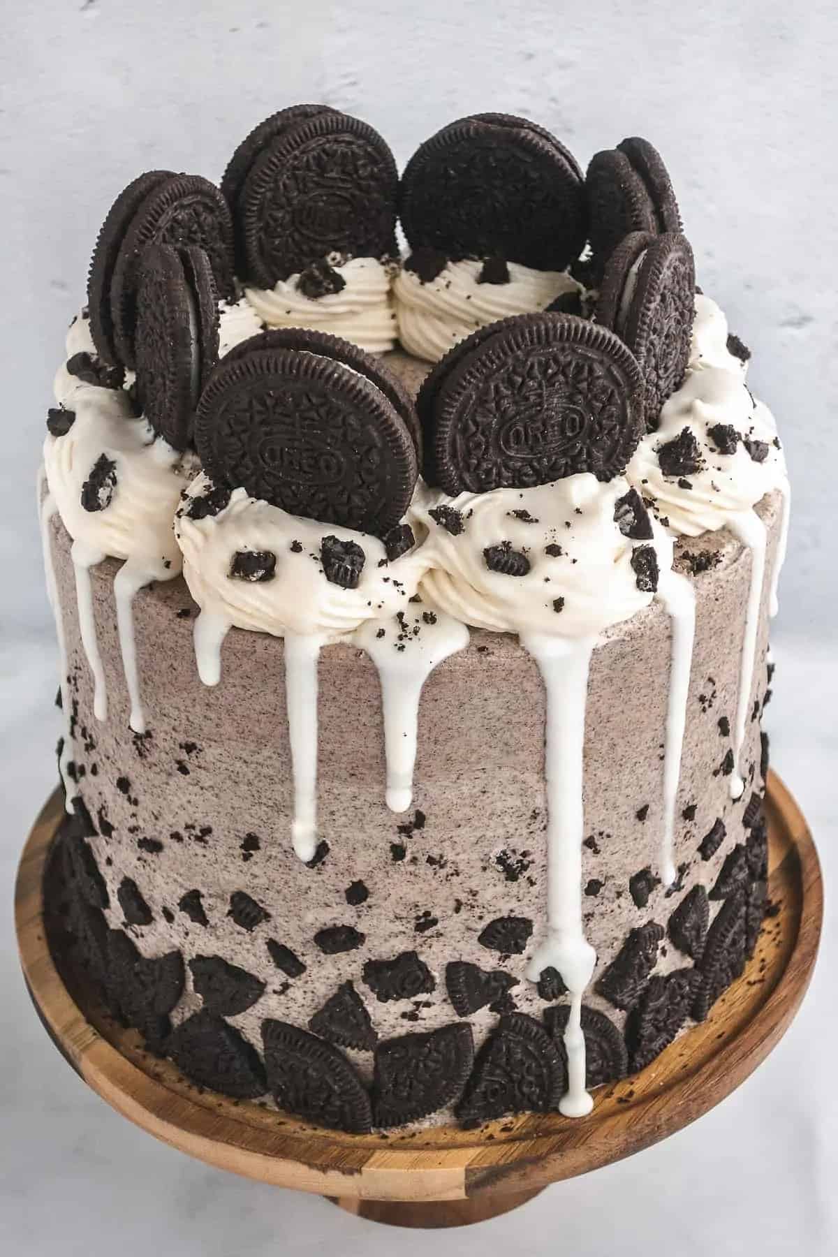A delectable oreo cake adorned with luscious icing and garnished with crumbled cookies on top.