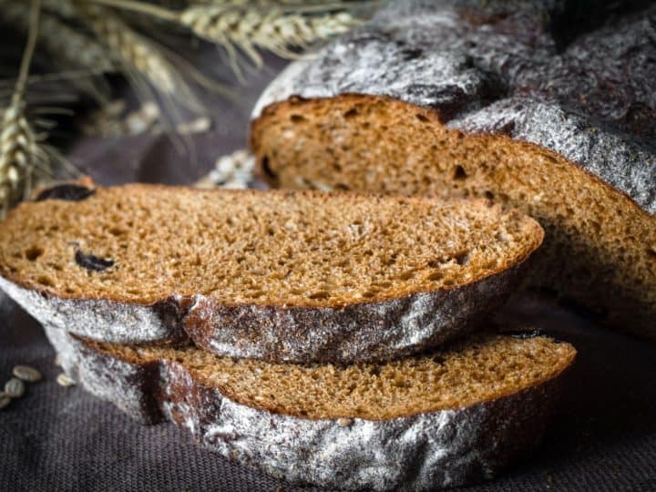 A loaf of bread with raisins and wheat.