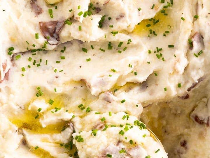 Mashed potatoes in a white dish with a fork.