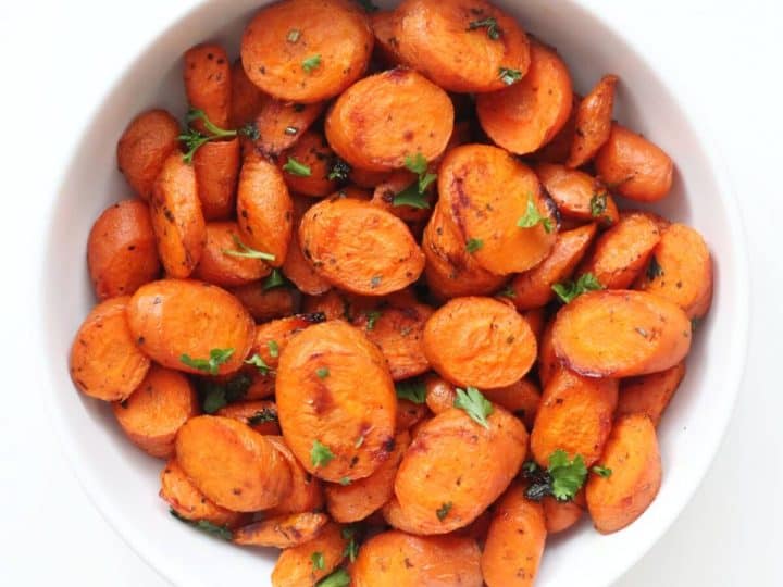 Roasted carrots in a white bowl.