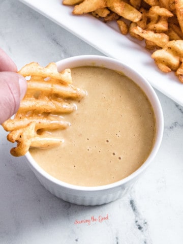 chick fil a sauce, copycat,in a white ramekin, waffle fry being dipped into the sauce.