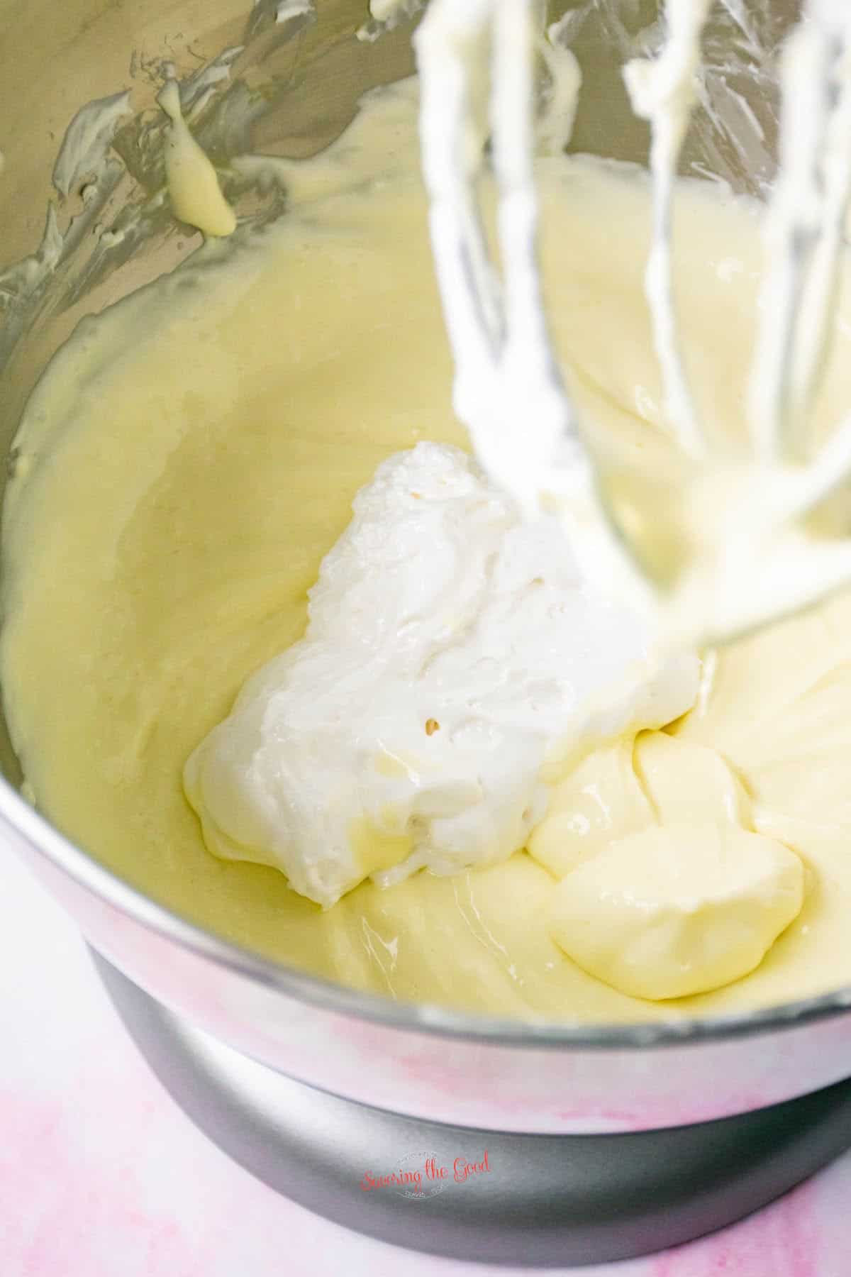 diary ingredients in a stand mixer bowl with whip attachement.