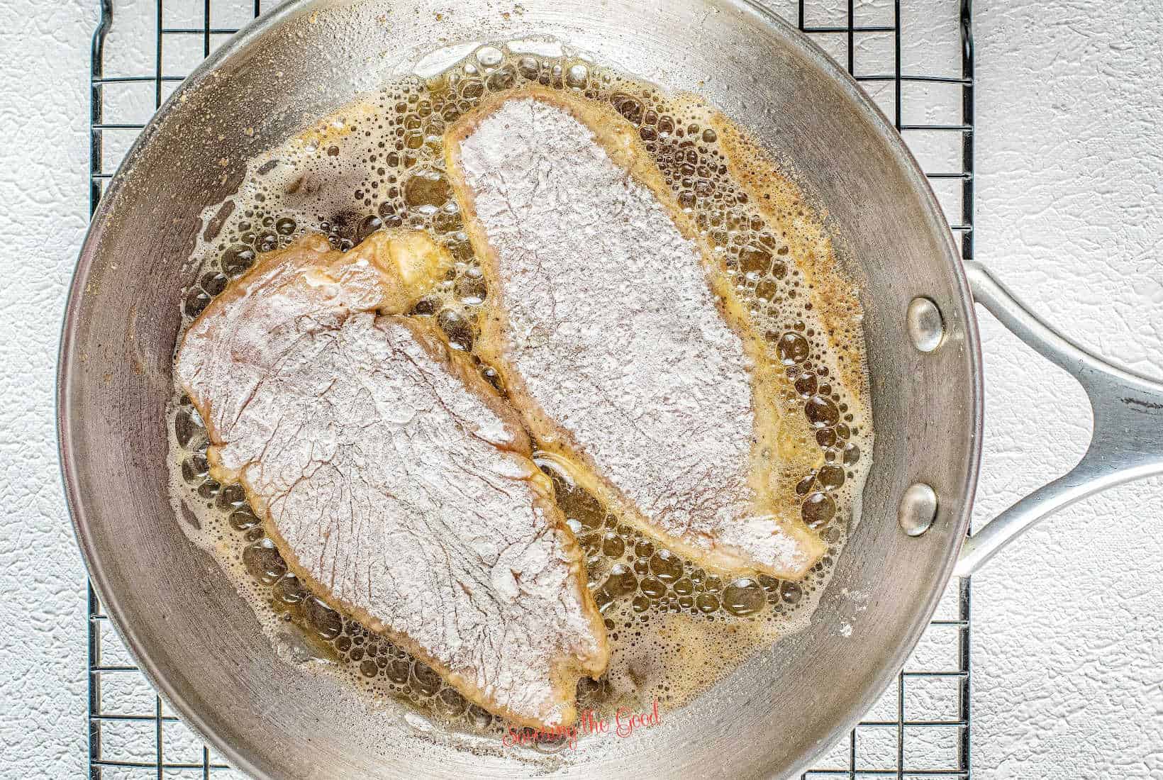 flour dredged chicken cutlets pan frying in olive oil and butter.