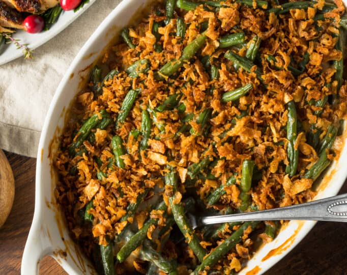 Green bean casserole with gravy on a table.