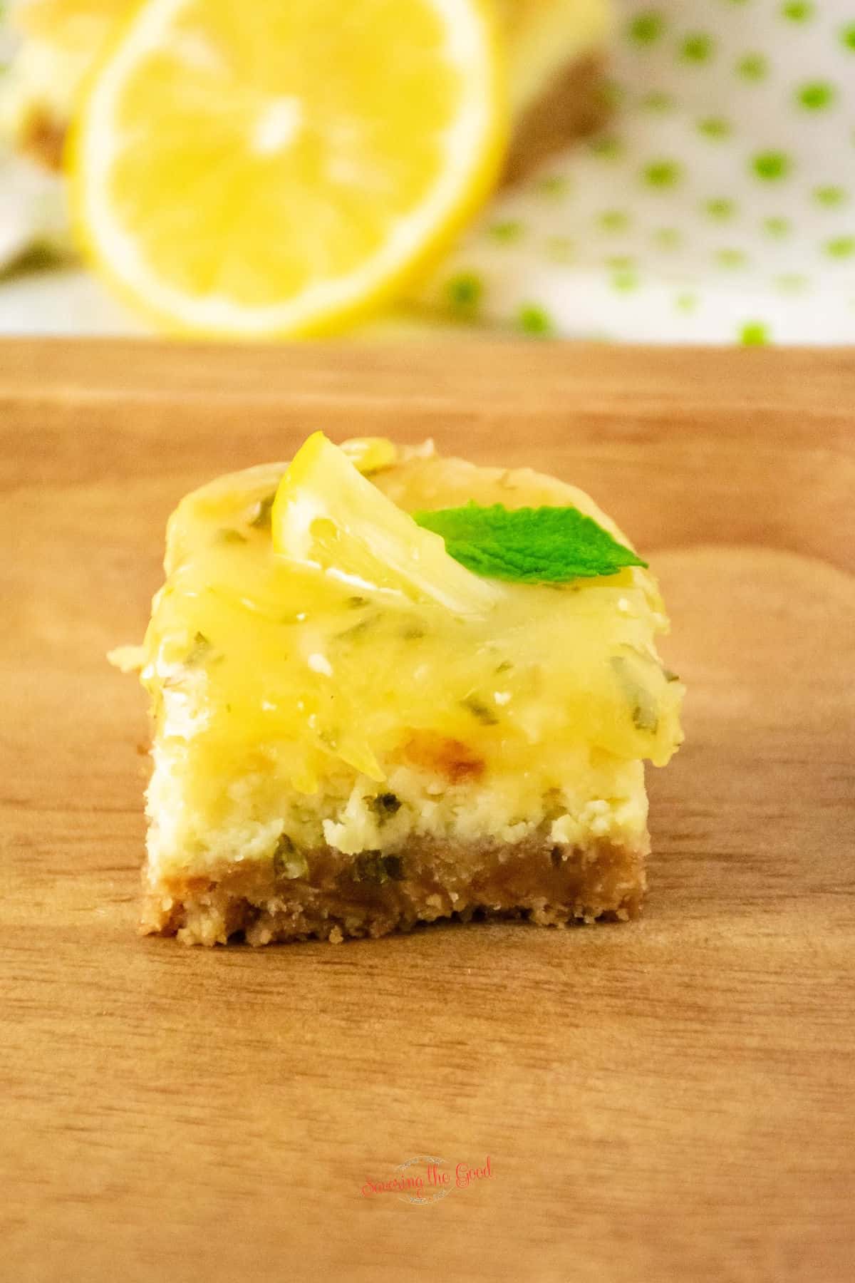 lemon cheesecake bar with mint leaf garnish
