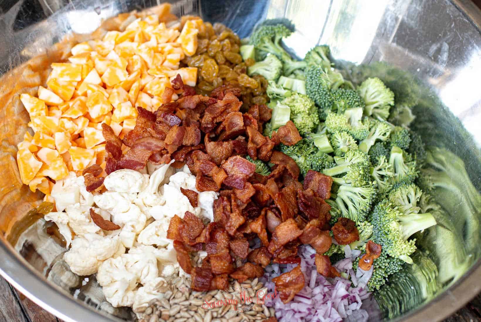 horizontal image of Amish broccoli salad in a bowl, with bacon on top.