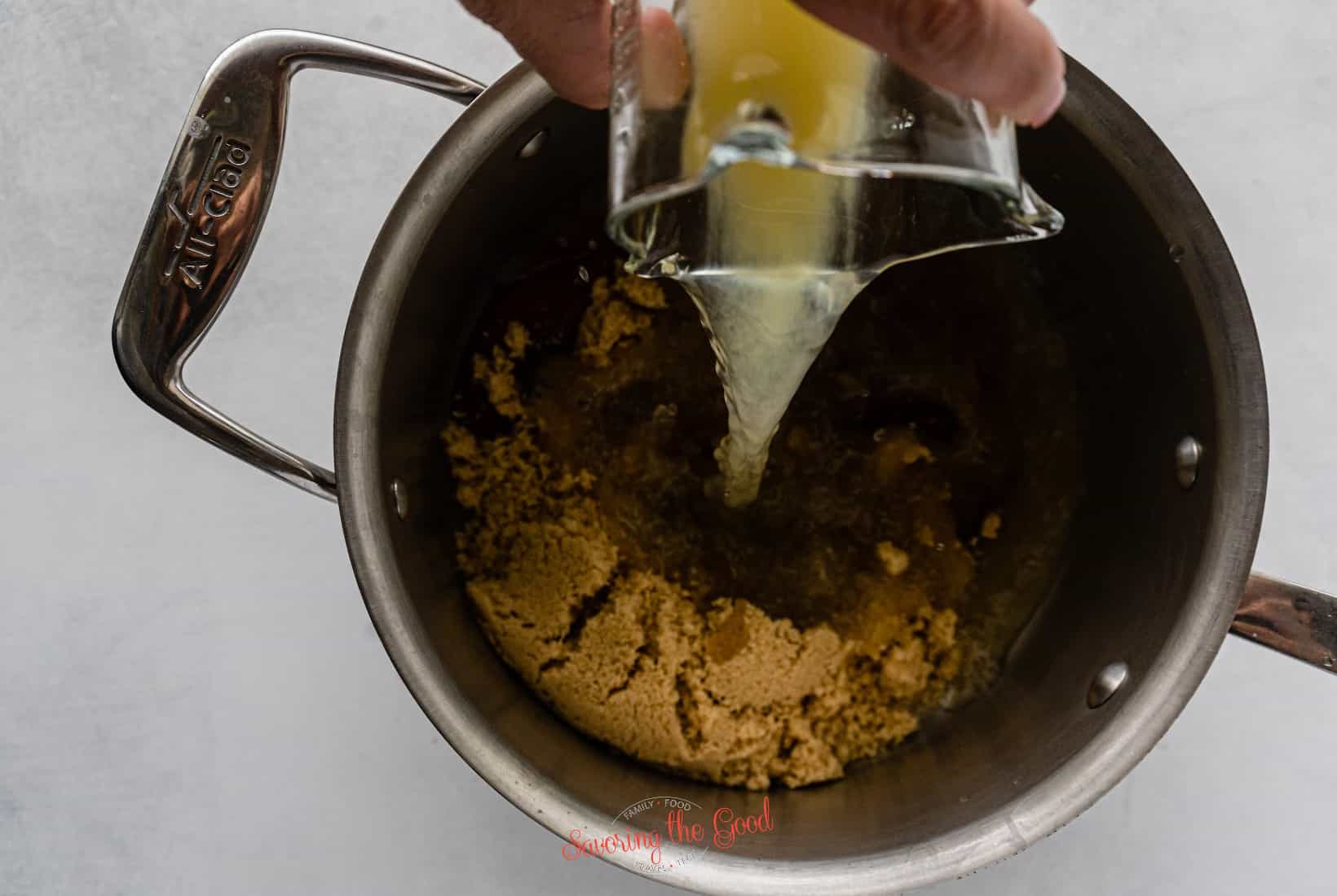 pineapple juice being added to the brown sugar glaze.