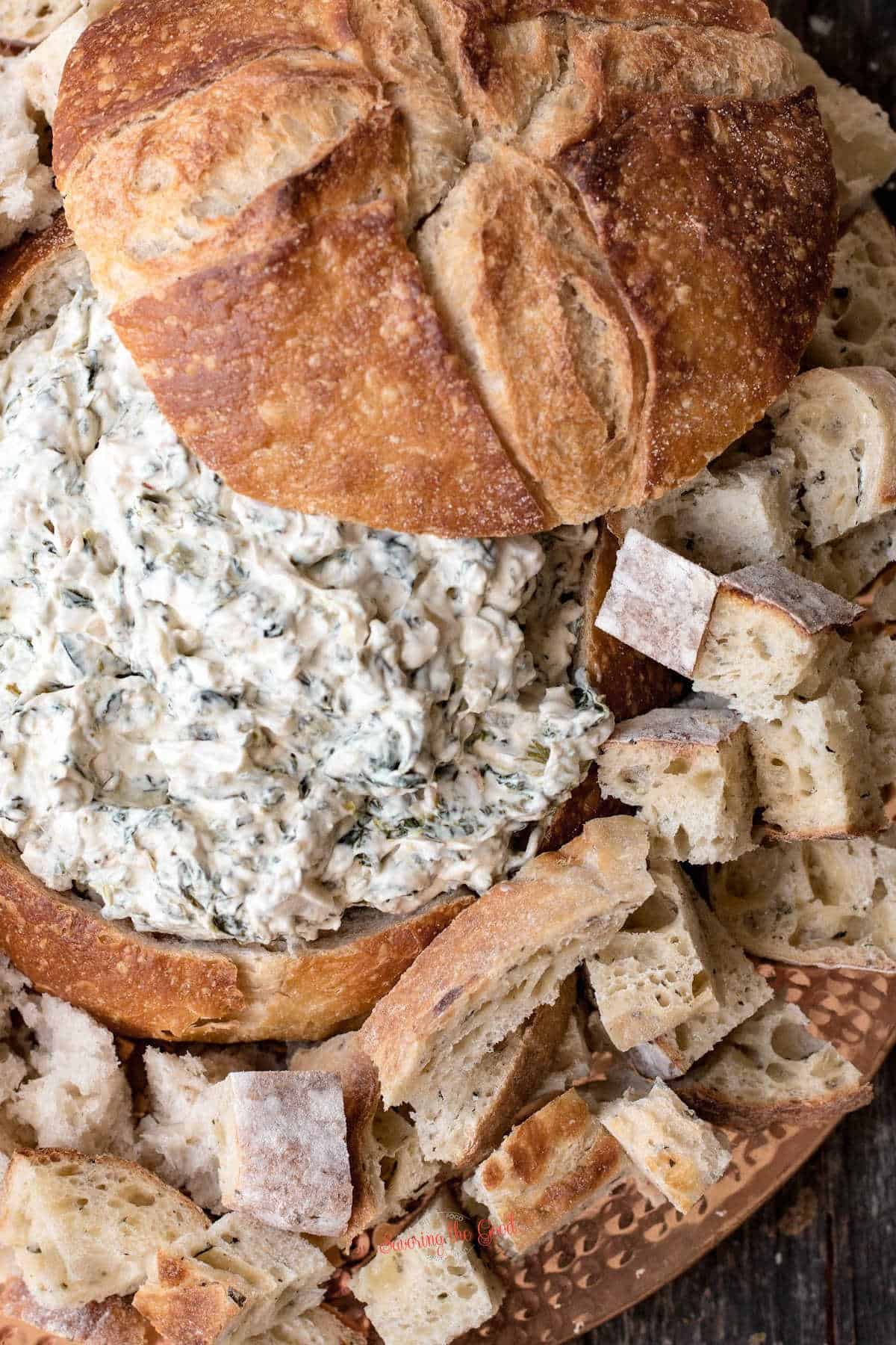 Knorr Spinach Dip in a bread bowl with bread cubes.