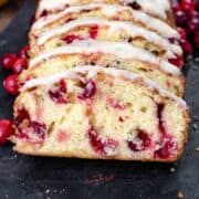 orange cranberry bread with orange icing, sliced.