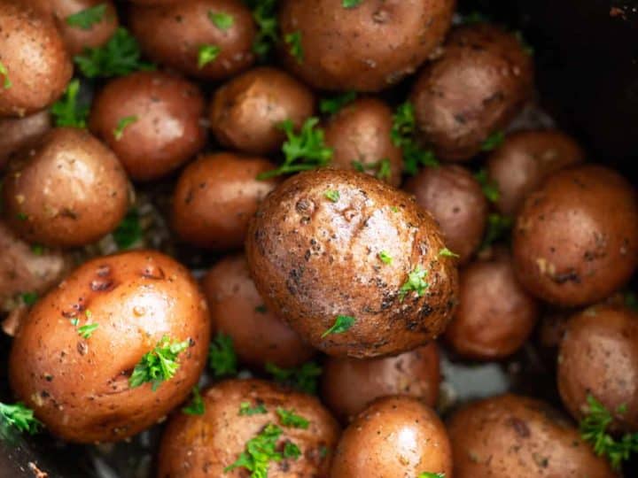A pot of seasoned baby potatoes, sprinkled with parsley, transforms this simple dish into a delightful recipe choice.