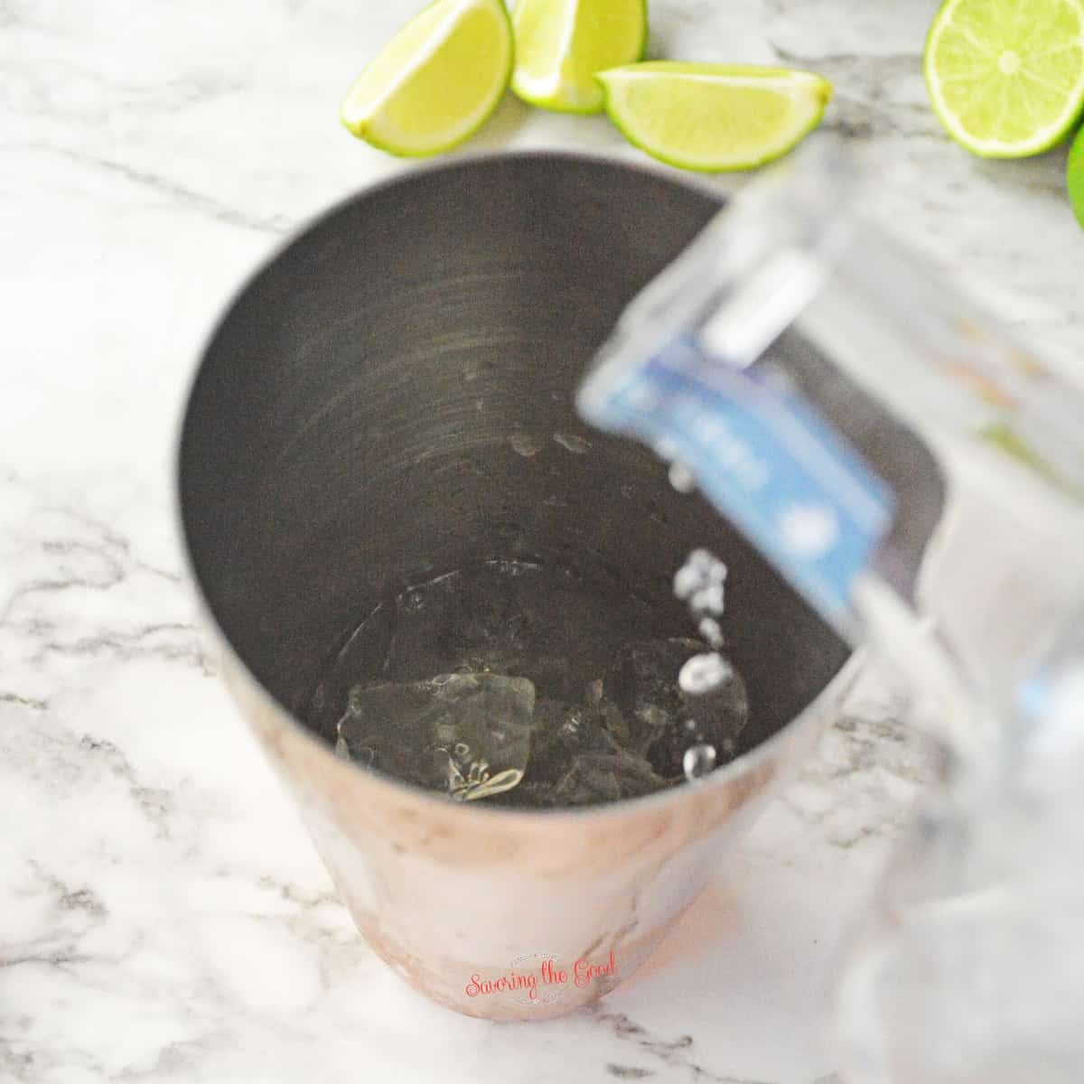 tequila being added to the ice filled shaker.