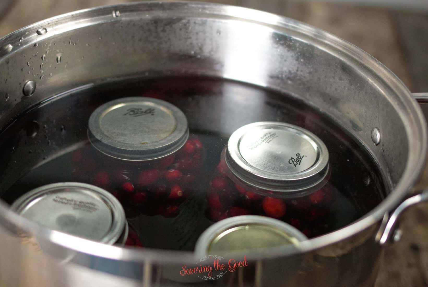 4 quart jars of cranberry juice processing in the water bath canner.