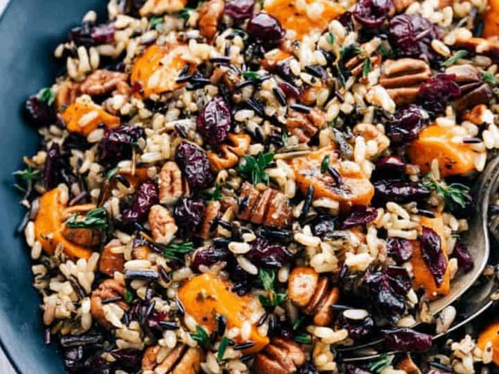 A plate of wild rice salad with sliced sweet potatoes, pecans, cranberries, and herbs makes a delightful side for lamb chops.