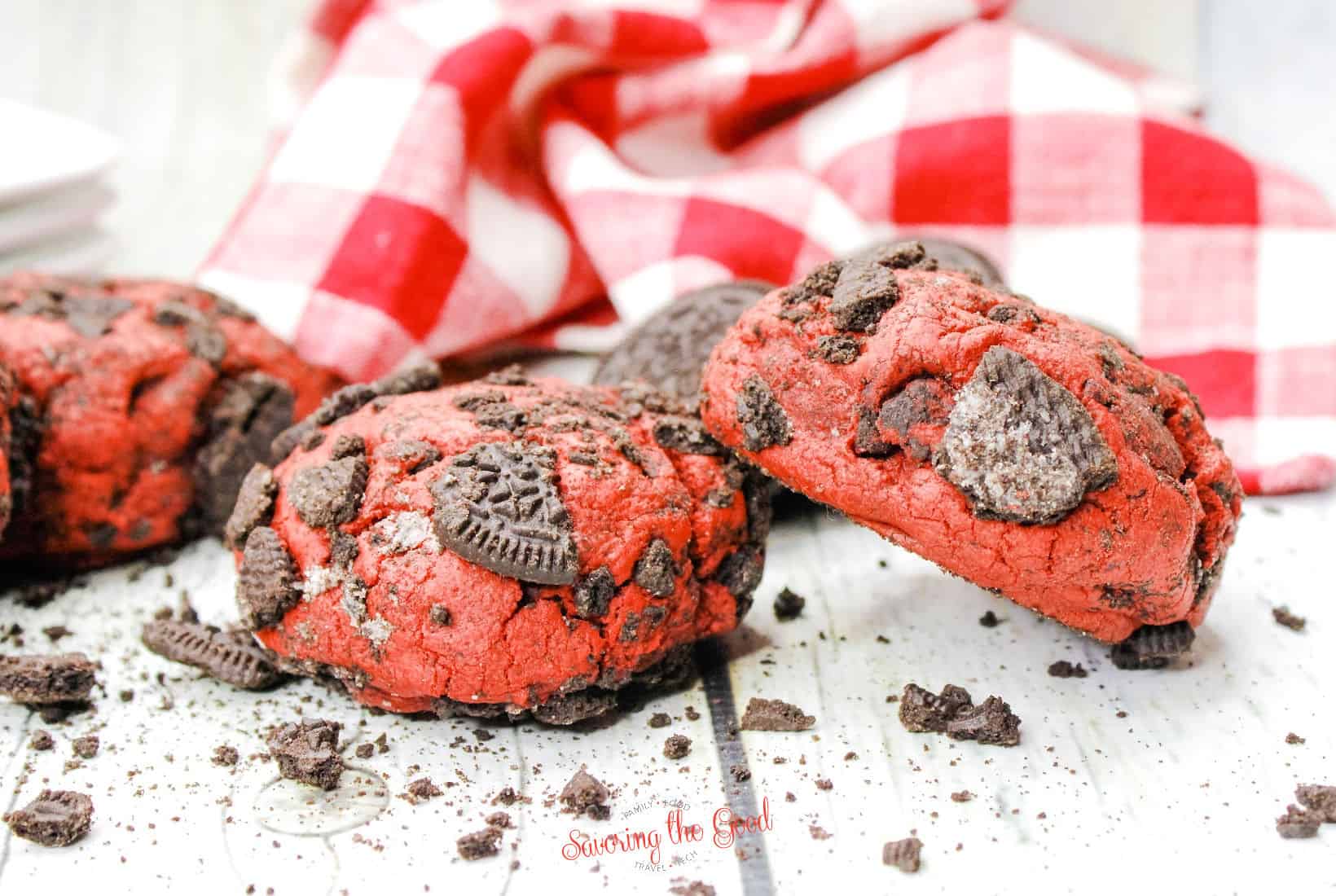 horizontal image of 2 Oreo Red Velvet Cookie with cookie crumbs around the base.