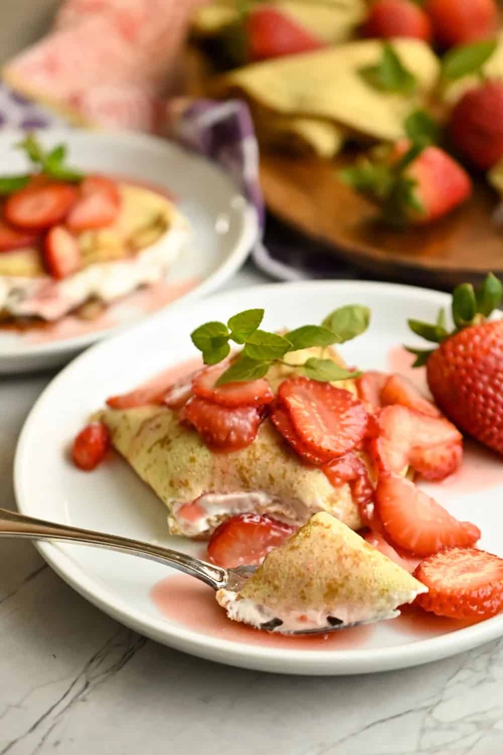 Strawberry crepes served on elegant white plates