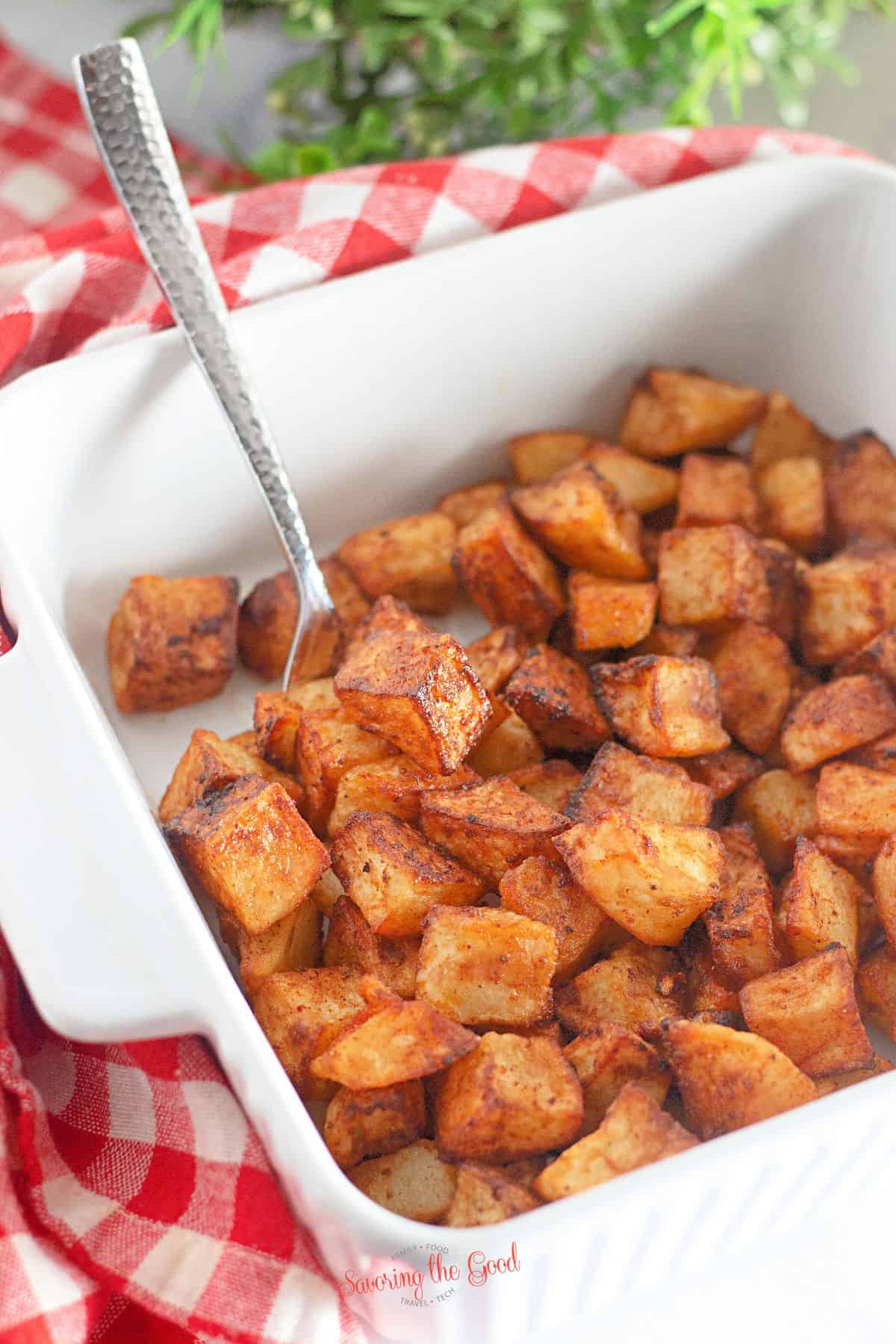 Air fryer breakfast potatoes in a white serving dish.