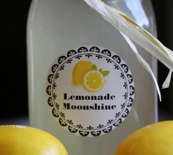 Indulge in the exquisite taste of homemade lemonade moonshine, crafted with care and presented beautifully in a mason jar adorned with fresh lemons. Explore enticing moonshine recipes to elevate