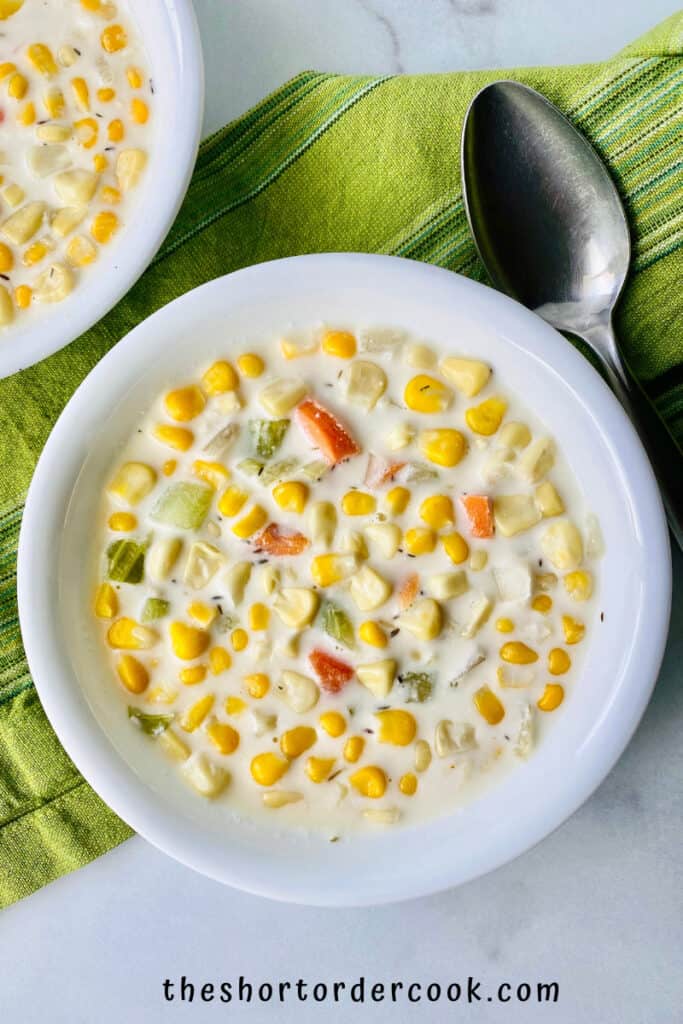 Slow-Cooker-Chicken-Corn-Soup-ready-to-eat-in-bowls-with-a-cloth-napkin-and-spoon