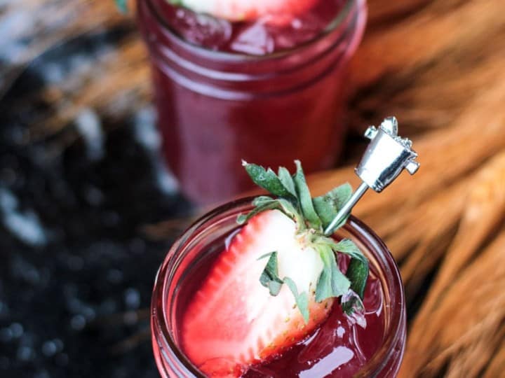 Two small jars of spiced cranberry moonshine