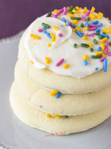 A stack of sugar cookies with sprinkles on top.