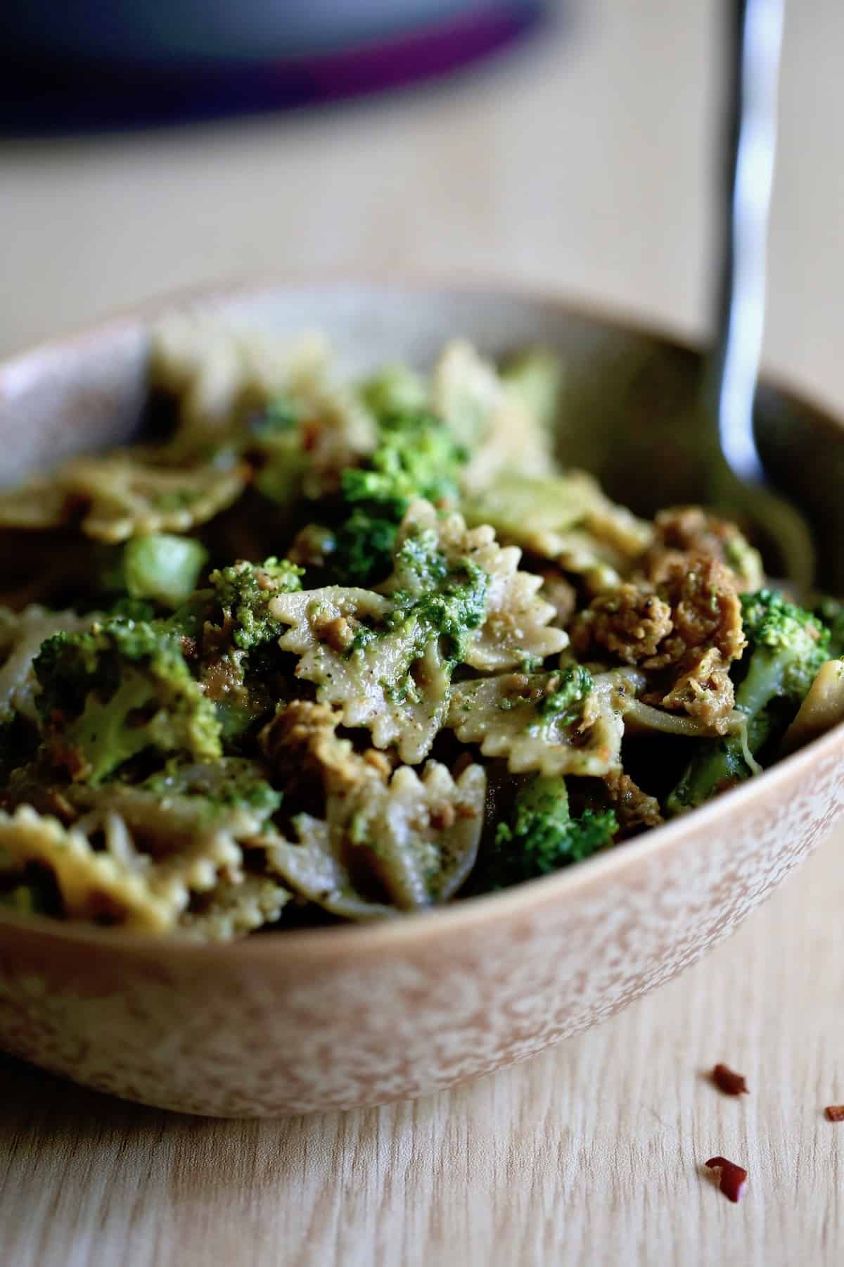 A delicious bowl of pasta featuring broccoli and meat, including beyond sausage.