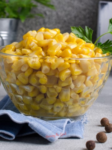 canned corn recipes, canned corn in a clear bowl.