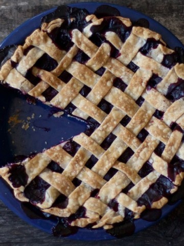 blueberry pie with a slice taken out of it.